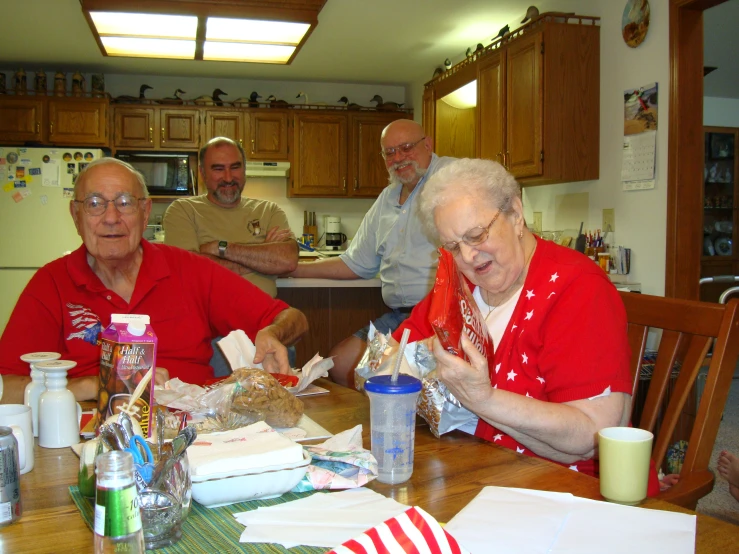 three men are sitting at the table talking