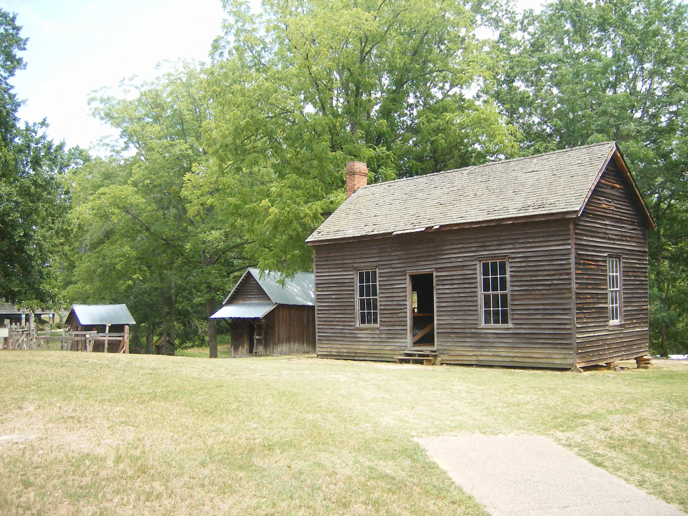 the old house in the middle of the grass