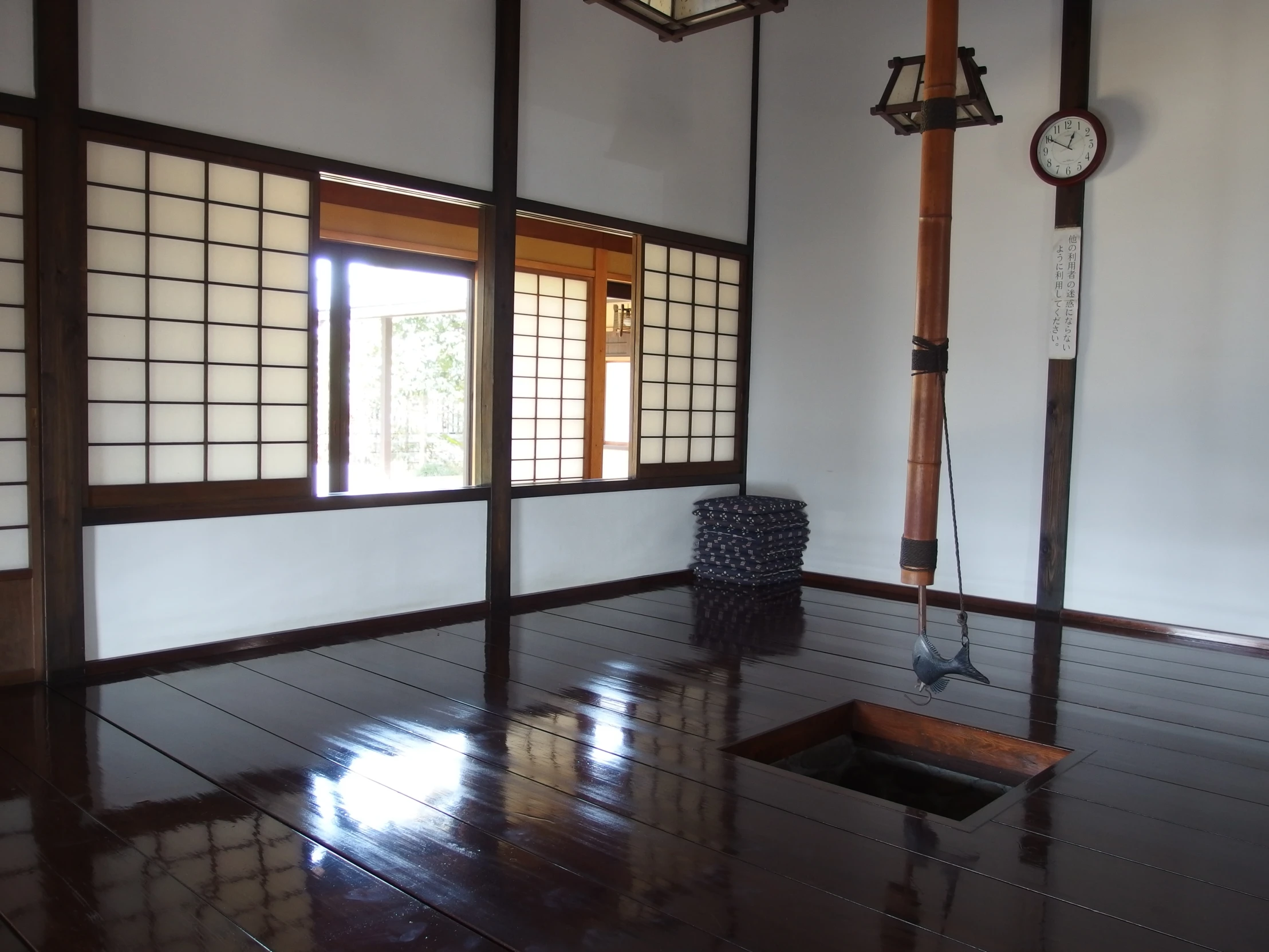 an oriental style room with tiled floors and a wood lantern light fixture