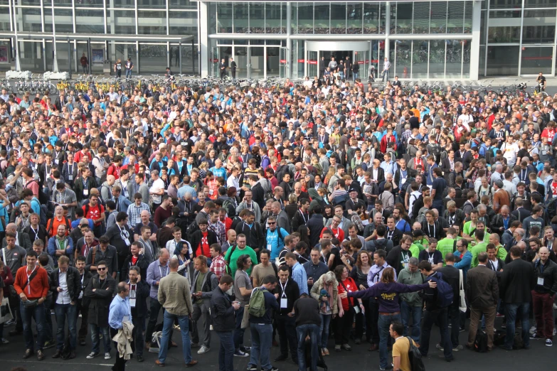 a large group of people standing in a parking lot