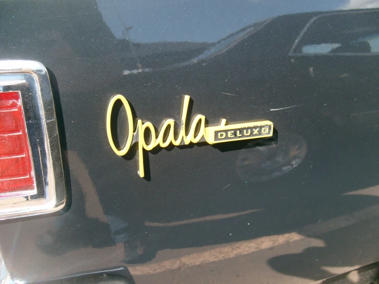 a black car with the word opal on it