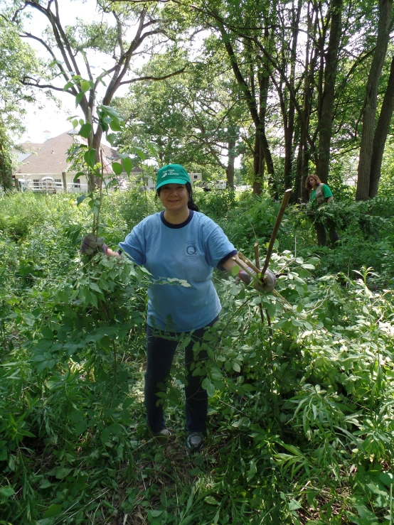 the woman is standing in the thickets of bushes