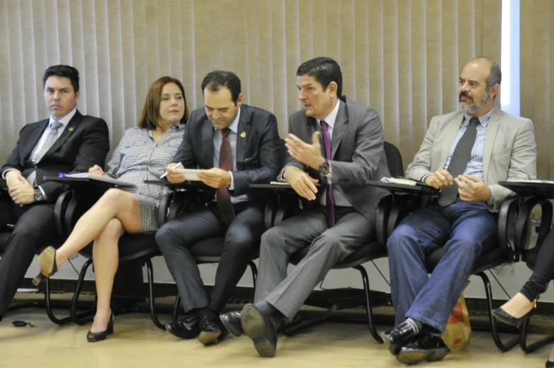 a group of people sitting on top of folding chairs