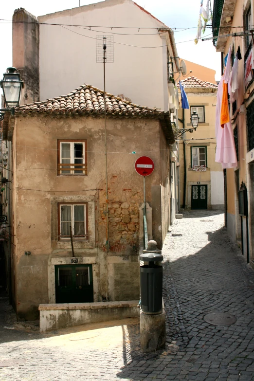 a building next to a lamppost on a stone street