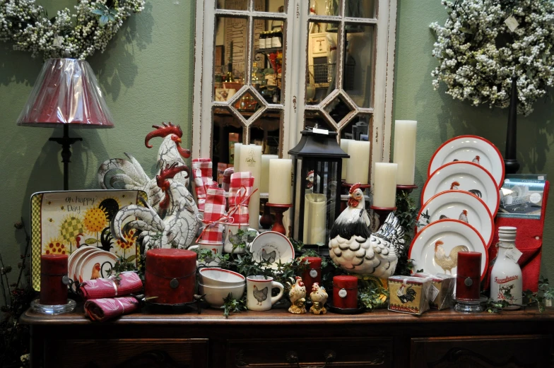 a holiday scene with rooster dishes and candles