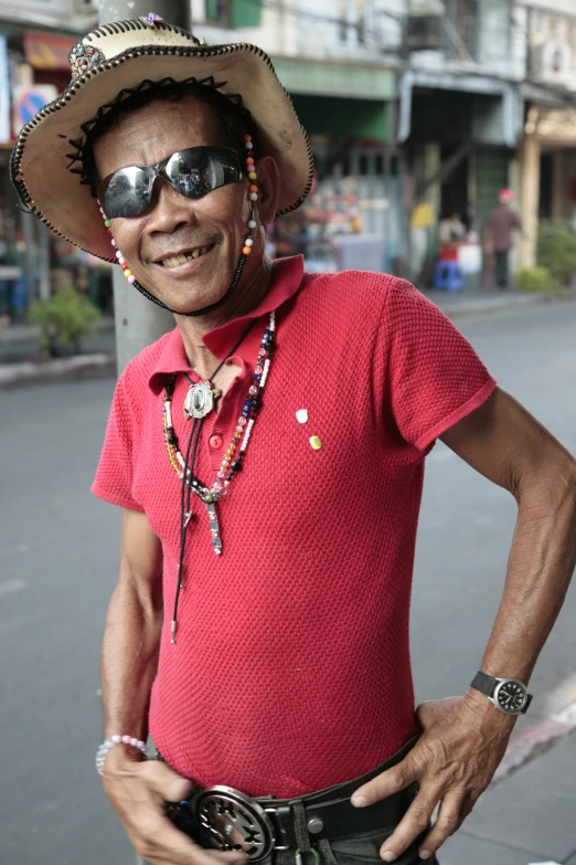 man in red shirt and hat wearing sunglasses