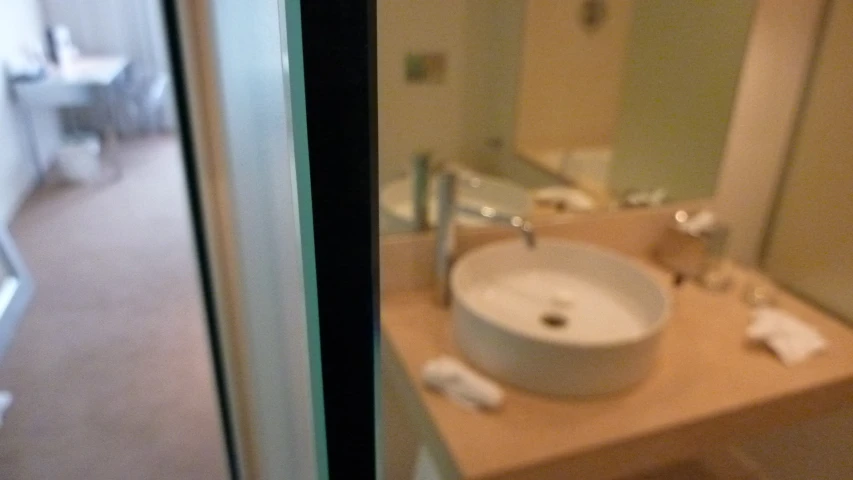 a sink with two faucets is shown next to the toilet
