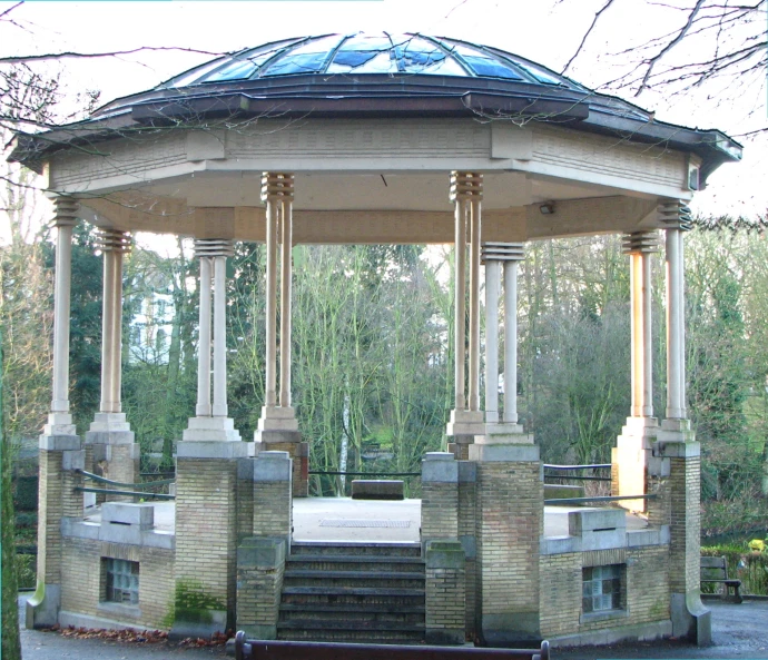 a large white gazebo surrounded by trees and stairs