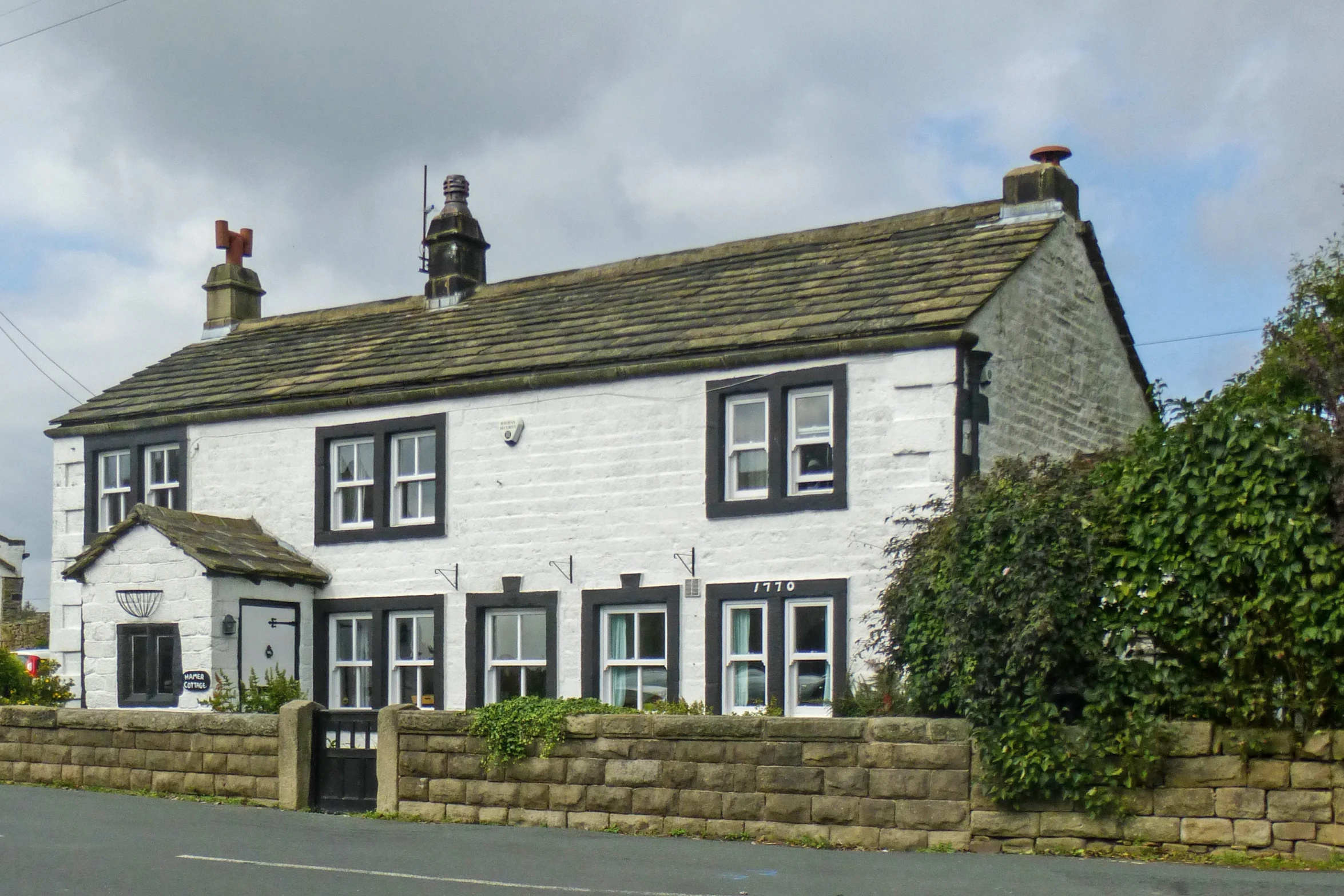 the front of a two story house with tiled roof