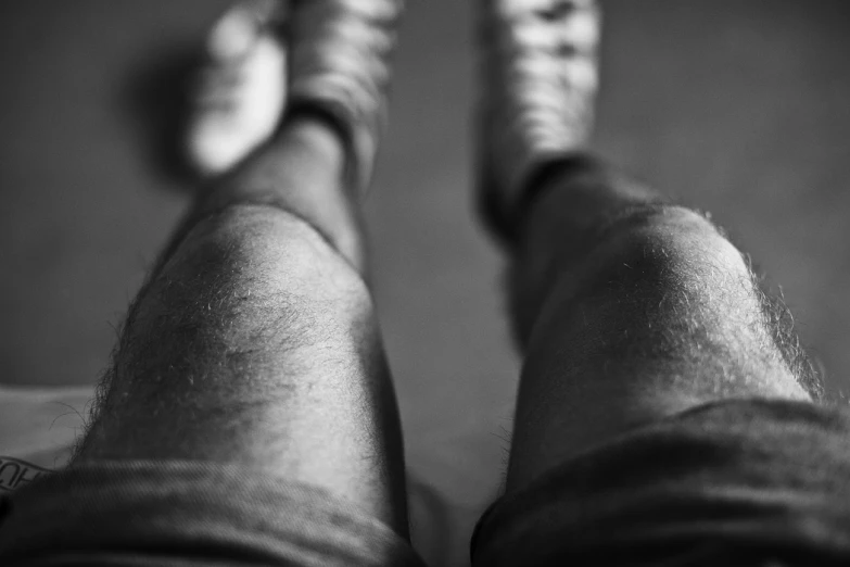 a person with their feet crossed while sitting on a couch