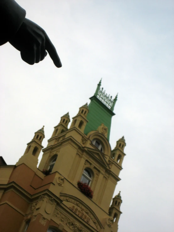 the large building has a pointed arm and an open window