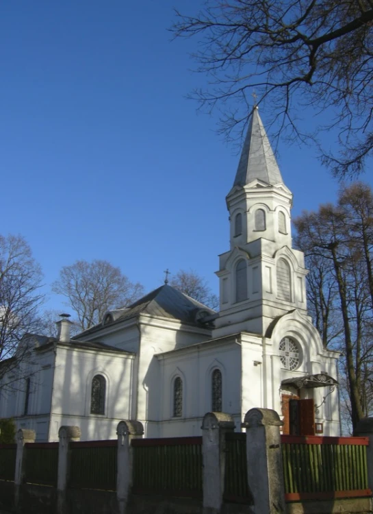 the church is next to trees and grass