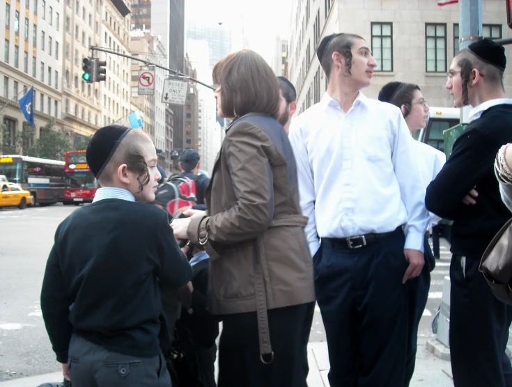 two men in brown jackets shaking hands at the crosswalk