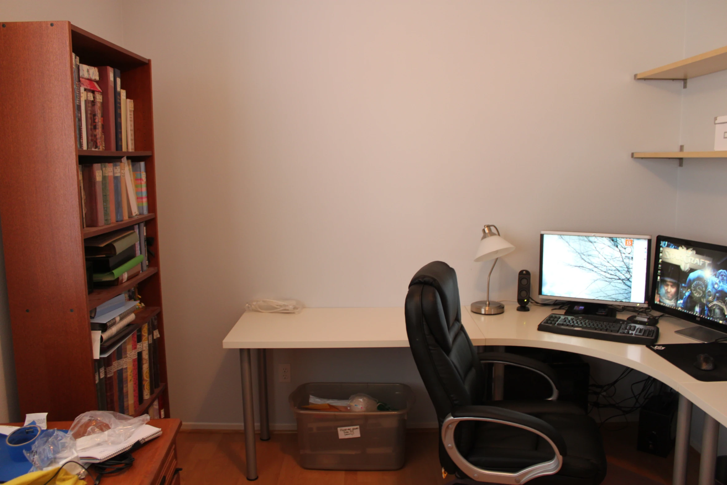 a computer desk with two monitors on it