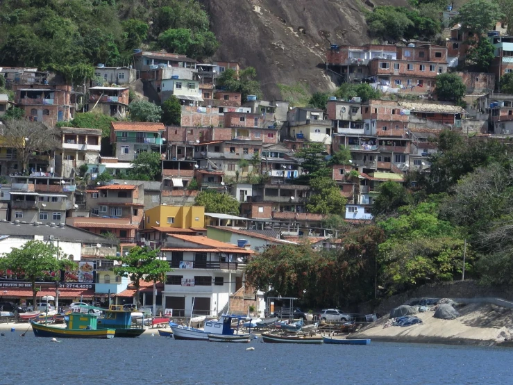 an urban slum on a hill next to water