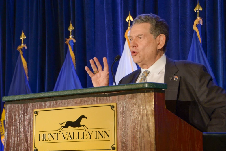 a man making a speech at a podium