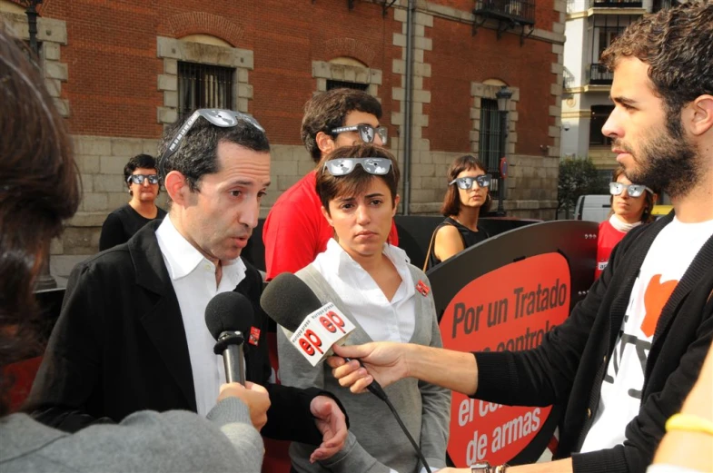 a man talking to a man with his glasses on