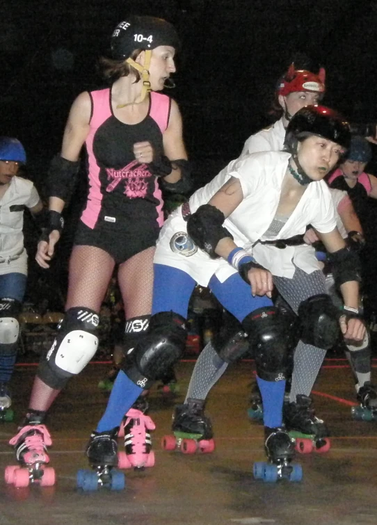 a group of rollerblading skaters on a court