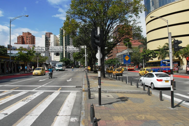 a busy city street filled with traffic next to tall buildings