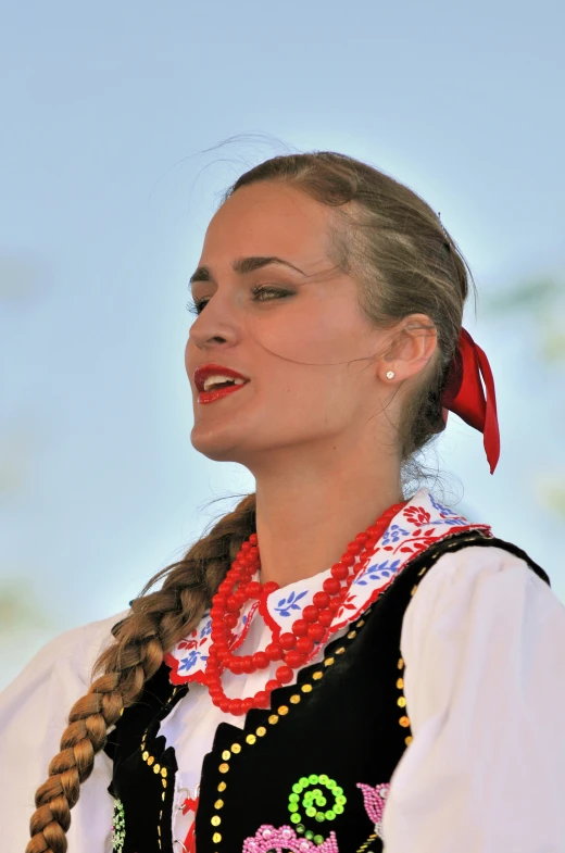 a young woman dressed up in folk clothing