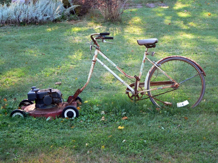 old rusty bicycle sitting in the middle of the grass