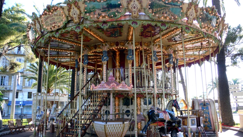 a merry go round sits in the middle of a palm tree