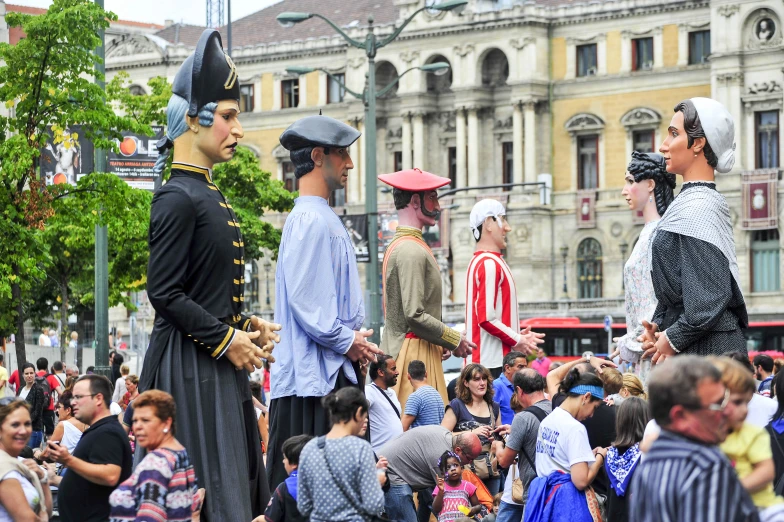 a crowd of people standing around two men in colonial costume