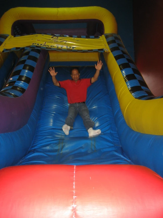 a man sitting on top of an inflatable slide