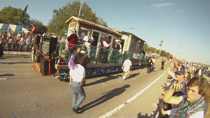 people are watching and taking pictures at the parade