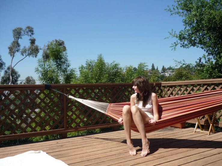 girl in white bikini in a red hammock