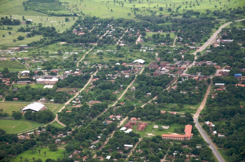 the aerial view of a large area with many trees and buildings