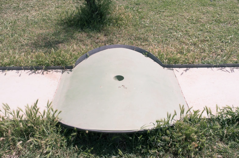 an outdoor toilet in a grassy yard