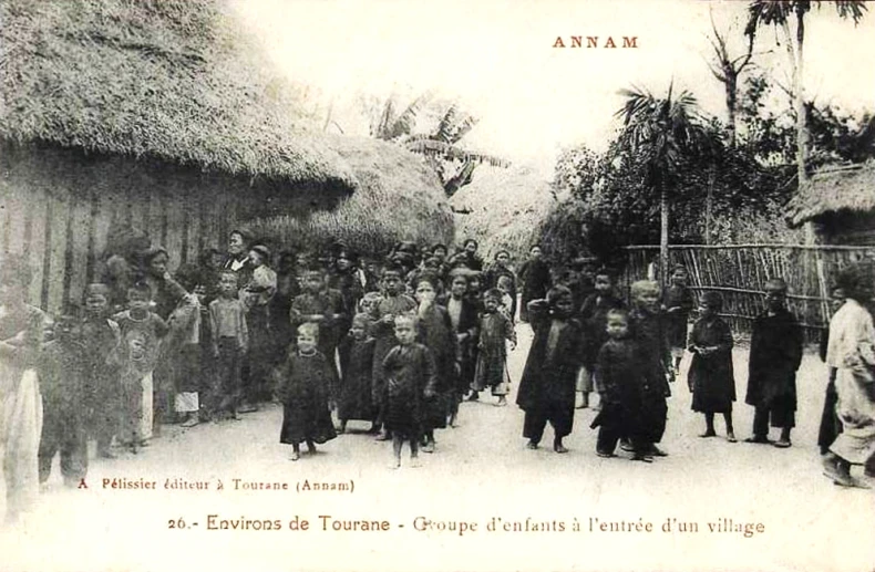 an old black and white po of people walking in front of houses