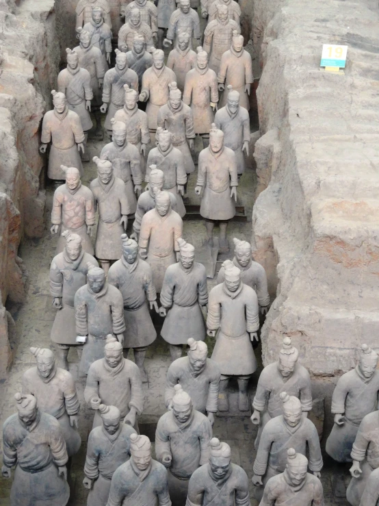 many large statues with heads in a group