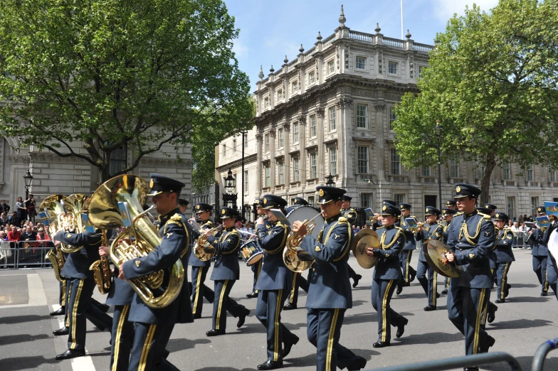 a marching band in the parade with people watching