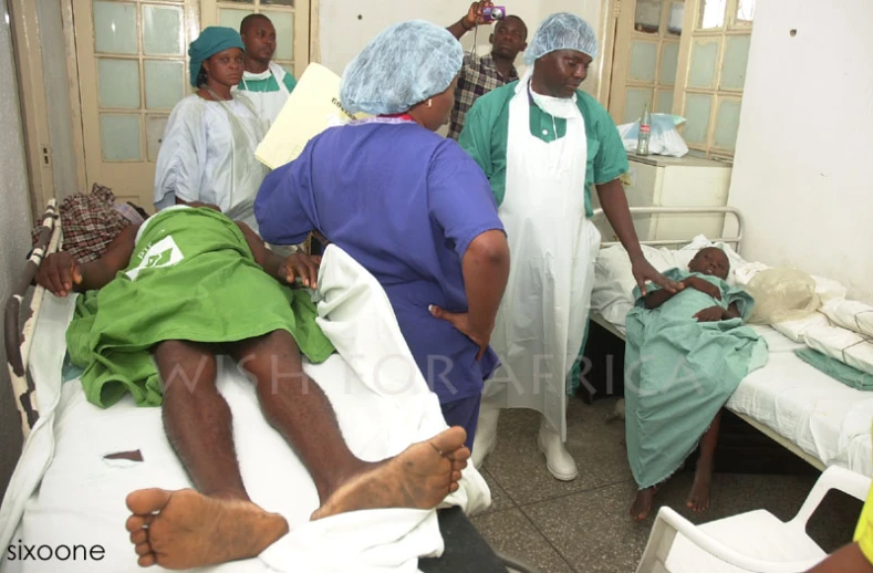 doctors tend to an injured patient in a hospital