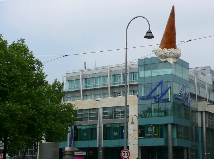 the building has an odd shaped cone on top of it