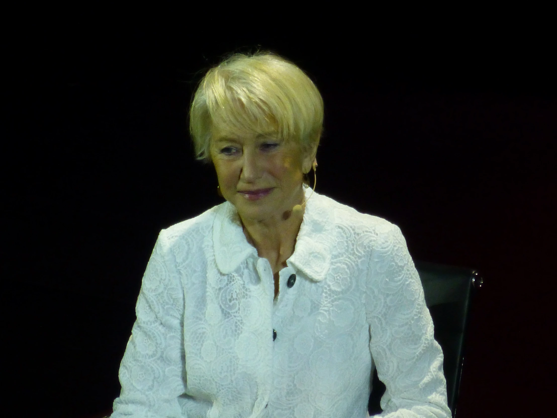 a woman sitting at a table in front of a computer