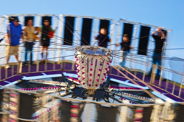 people are watching soing in the carnival rides