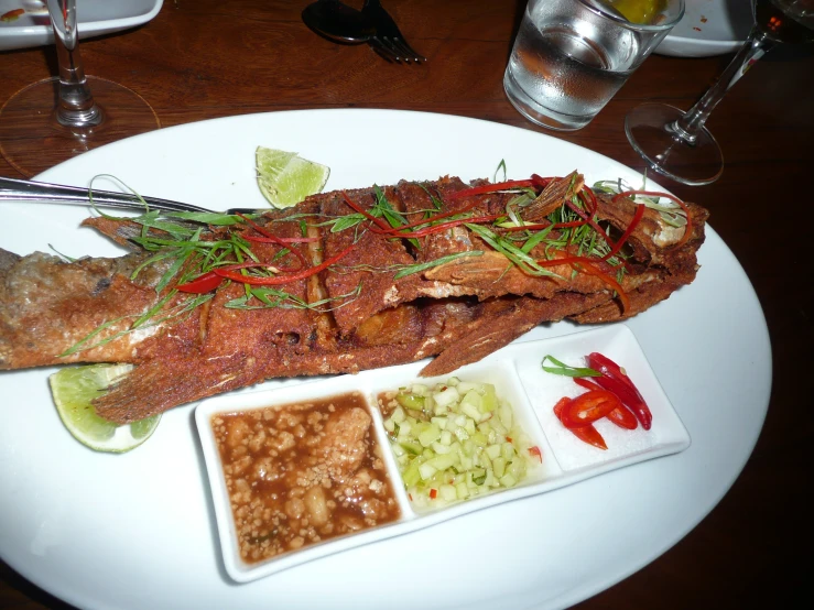 the white plate is full of food and on top of a table