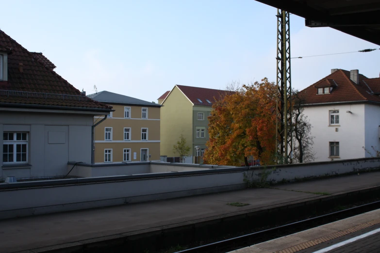 buildings and a train on the tracks near a platform