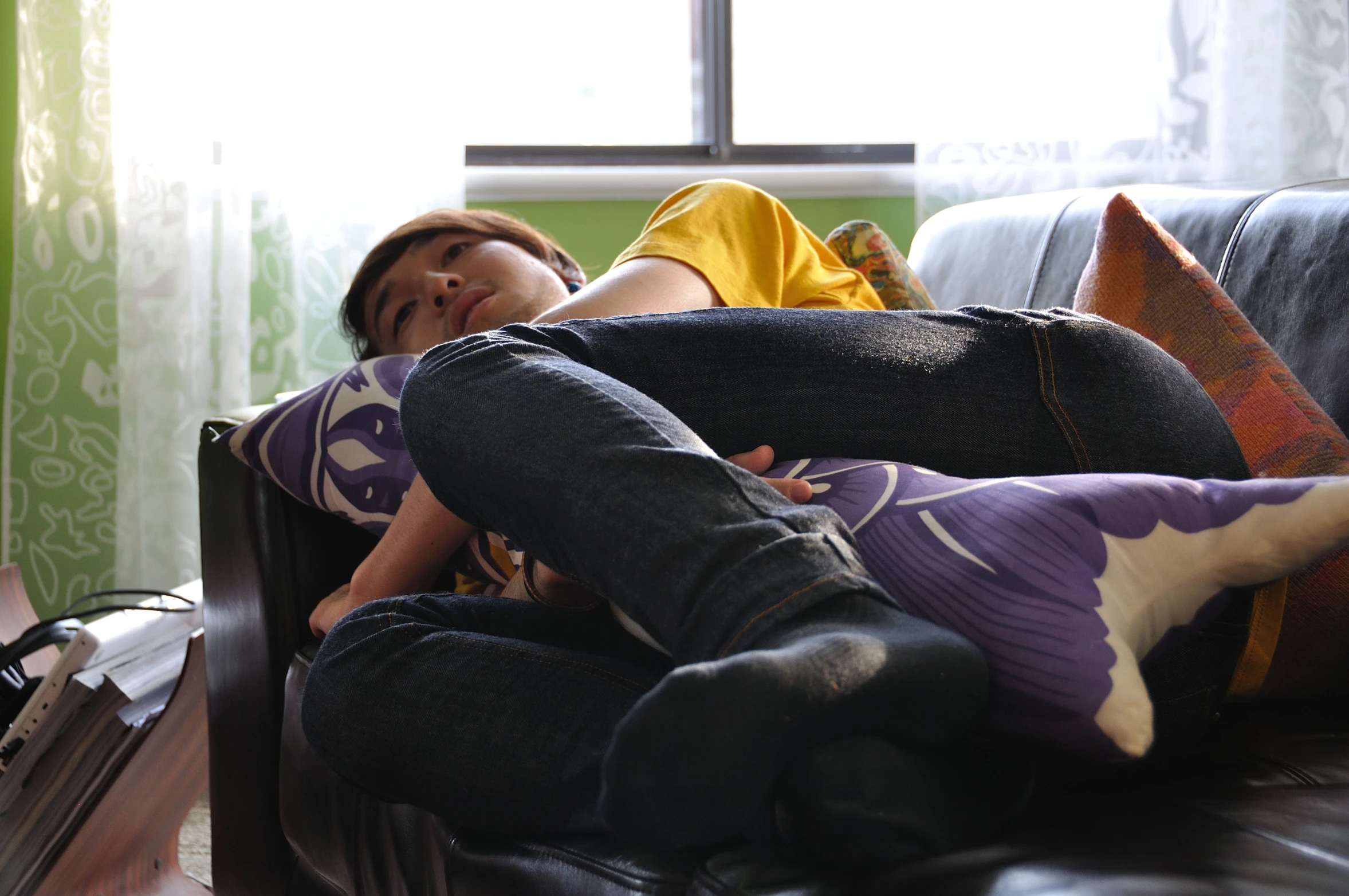 a person laying on a couch with their feet crossed