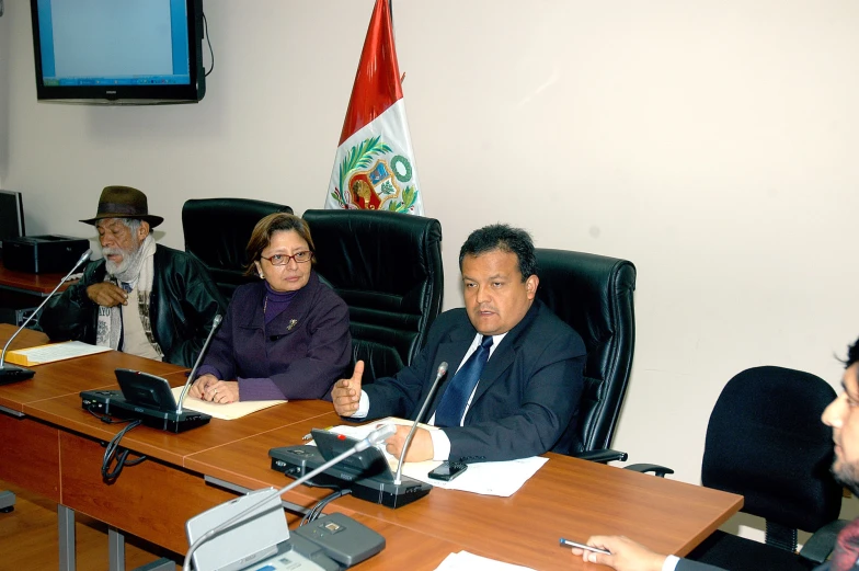 a group of people sitting around a conference table