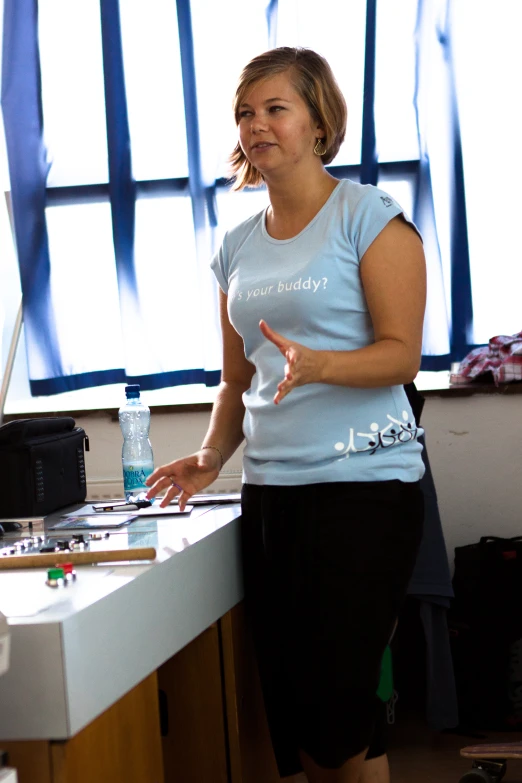 a woman pointing to her piece at a counter