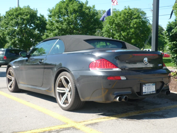 this is a black car parked on the street