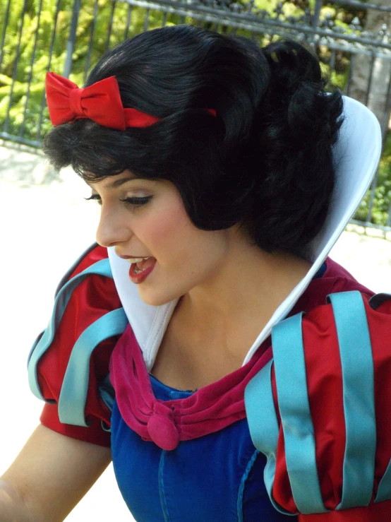 a woman is dressed like snow white with a bow