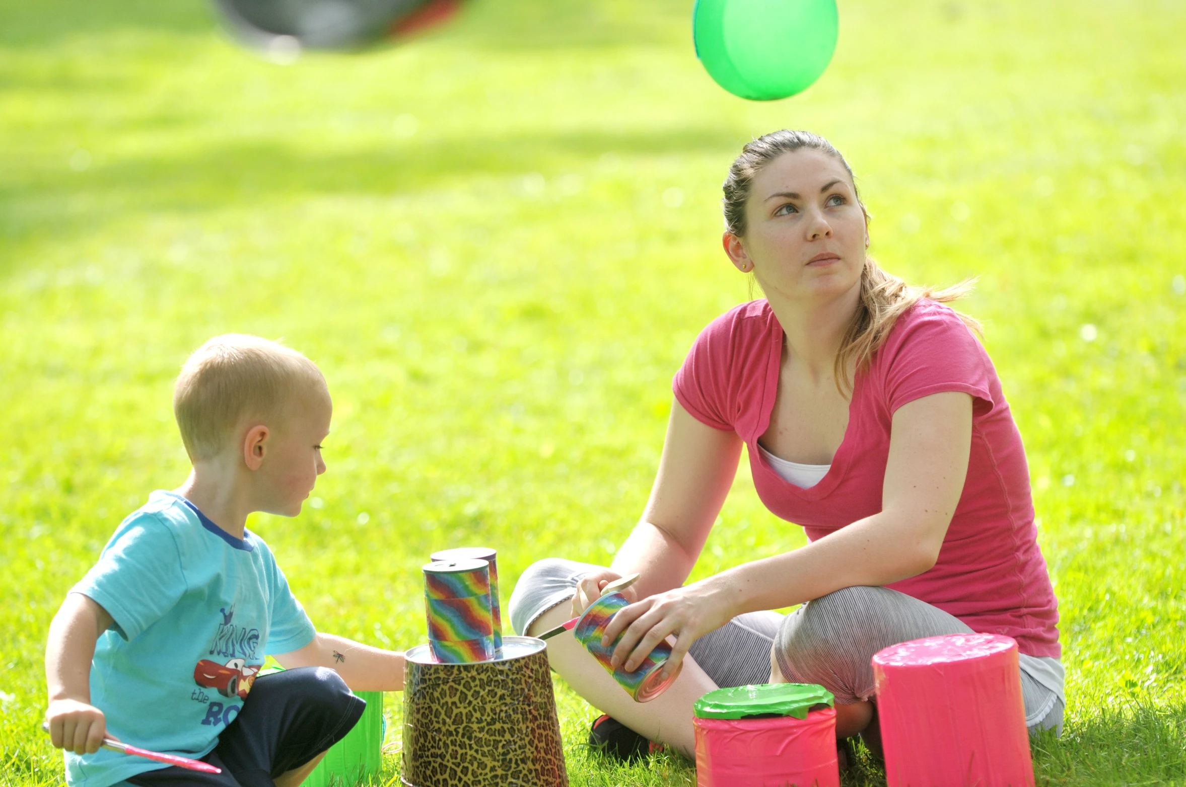 there is a little boy and a woman playing with items