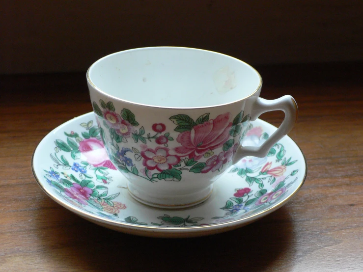 a cup with an ornate saucer and saucer