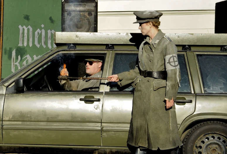 a couple of people that are in front of a vehicle