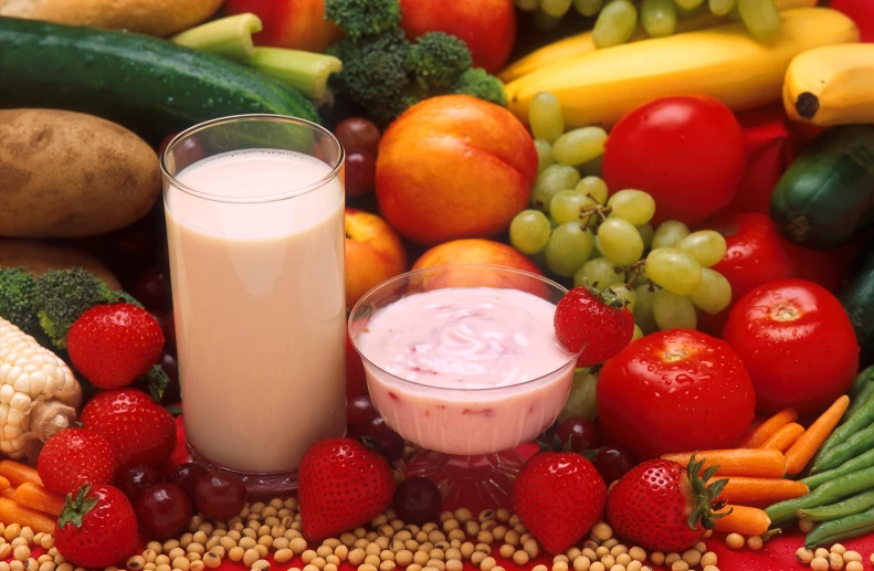 there is a fruit and vegetable display with smoothies